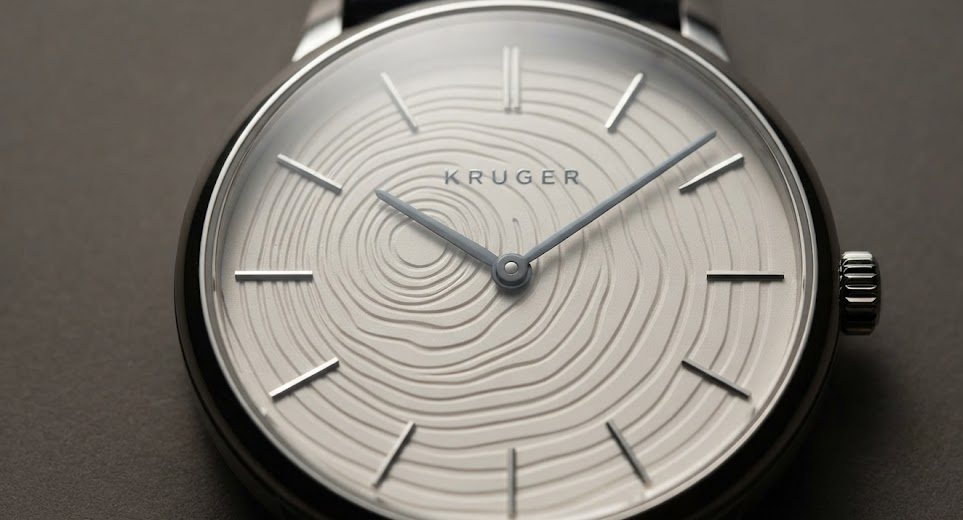 Warm off-white dial carrying growth rings